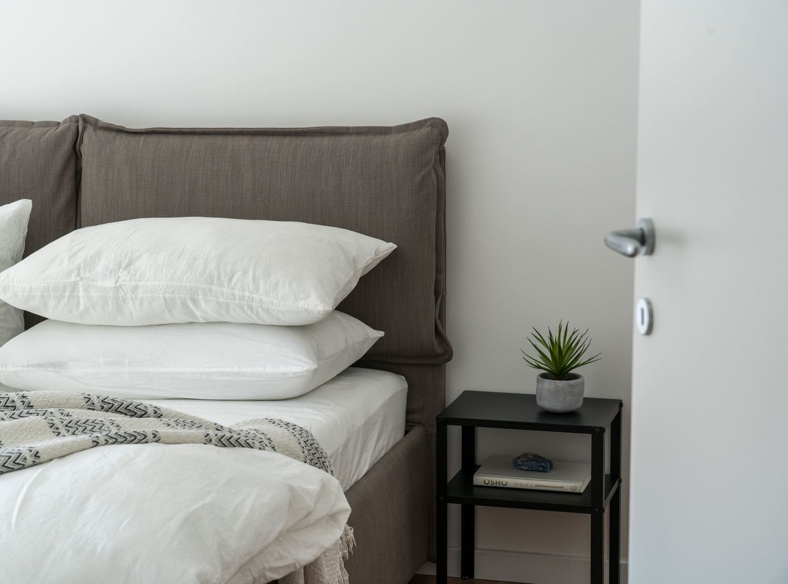 Bed made with white sheets